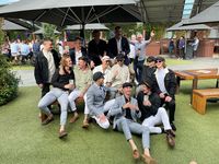 A group of guys posing at a pub.