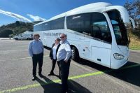 EV Tours & charter drivers standing in front of a bus.