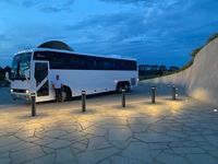 John standing next to the coach at sunset
